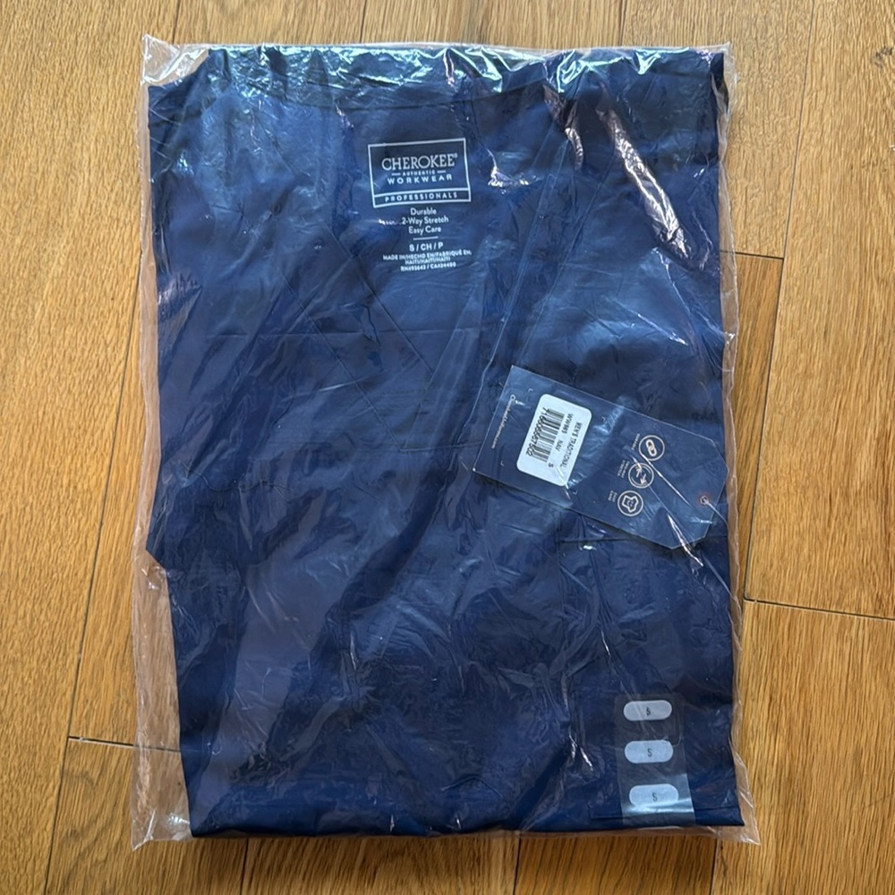 New unopened navy blue scrub top! Perfect condition. Durable, 2 way stretch.